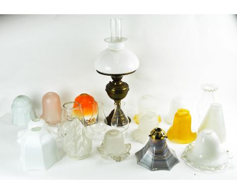 An oil lamp, Claxy lamp and 22 assorted glass shades