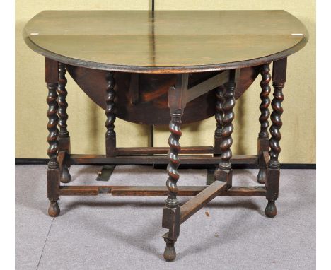 An oak barley twist drop leaf and gate leg dining table. Measures; 73cm x 108cm x 55cm.