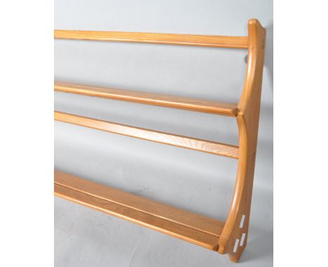 Lucian Ecrolani - Ercol - A 1960's retro vintage beech and elm wall mounted plate rack in the blonde colourway, 49.5cm high, 