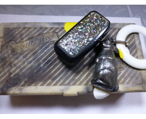 Marbled cigarette box with inlaid snuff box and a white metal rabbit baby teething ring