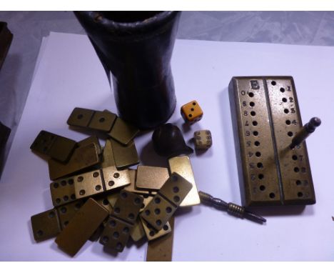 Antique gaming pieces, brass dominoes, cribbage scoreboard, dice cup and dice