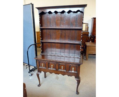 A late 19th, early 20th century oak dresser, with two shelf galleried back, above two drawers and shaped lower frieze, on sha