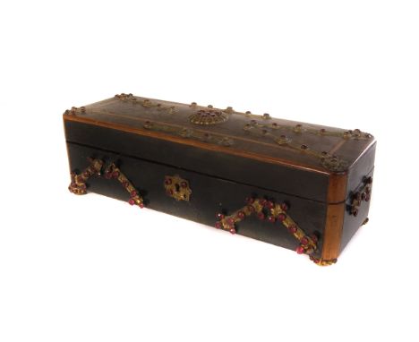 A vintage walnut glove box, the lidded box having added brass and red gem set decoration over inlaid design