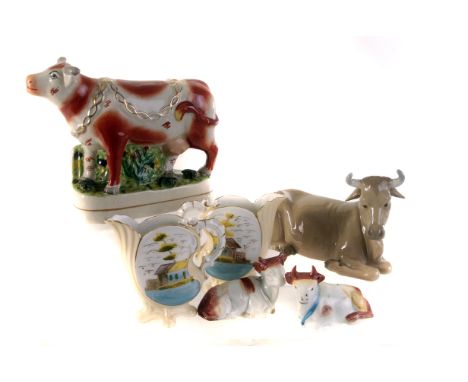 A small group of porcelain and pottery cow figures, including a Nao example, plus a pair of porcelain jugs and other ceramic 