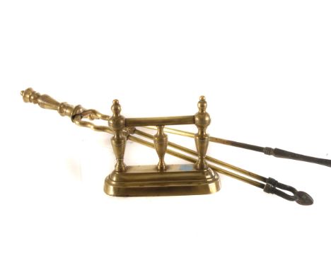 A selection of brass fire furniture, comprising and pierced design fender, a pair of fire dogs, and three Victorian brass coa