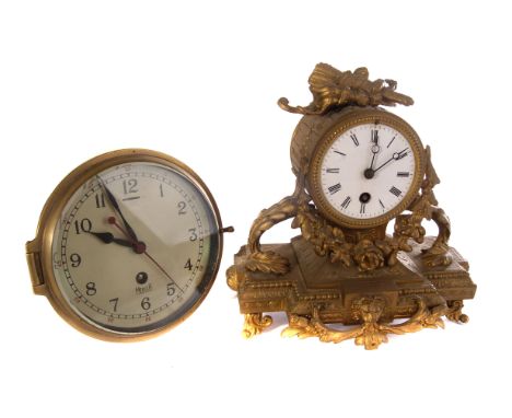 A gilt mantle clock, having swag design and lions head to front, together with a Mercer bulk head clock (2)
