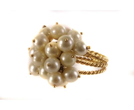 An 18ct gold and pearl dress ring, the pearls set on loose links, mounted on three twist design bands, size K 1/2, approx 10.