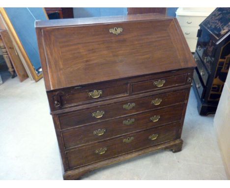 A mahogany bureau, having two short above three long drawers, brass handles and fittings, on bracket feet