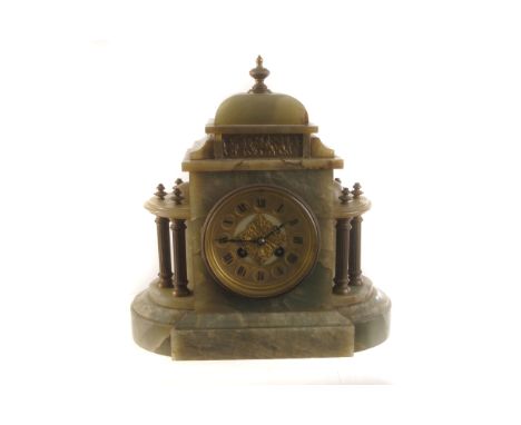A green onyx mantle clock, having black Roman numerals to gilt face, flanked by column design, with brass embossed panel to t