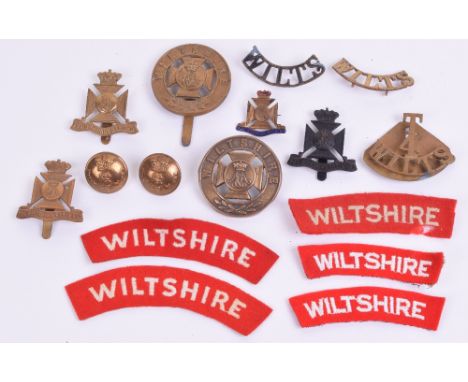 Badges and Insignia of the Wiltshire Regiment, consisting of brass other ranks helmet plate centre, brass Pagri badge with sl