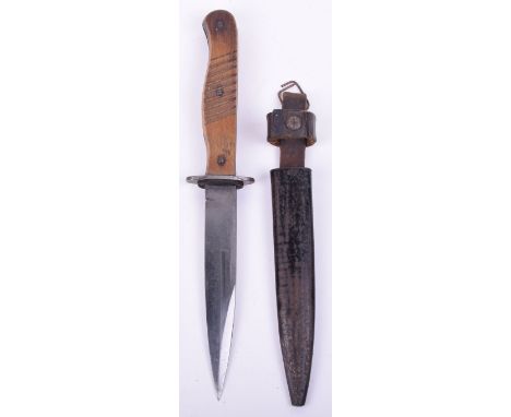 Imperial German Fighting Knife, two piece wooden handle. Housed in the original black painted finish scabbard. Leather belt l