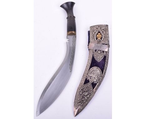 Presentation Gurkha Kukri, having a one piece carved horn grip with brass mounts, housed in a fine blue felt covered scabbard