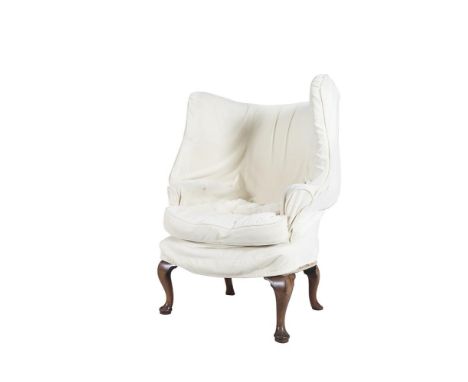 A GEORGE III WALNUT FRAMED UPHOLSTERED WING BACK ARMCHAIR, covered in a tapestry style material, and with loose cushion and c