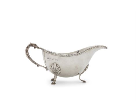 A MODERN IRISH SILVER SAUCE BOAT, Dublin 1973, of typical oval form, decorated with Celtic banding and raised on shell capped