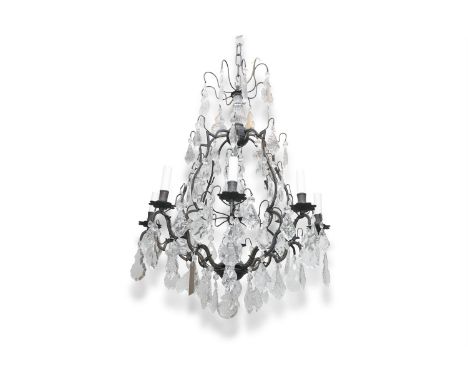 A FRENCH METAL FRAMED CHANDELIER, of teardrop form, with eight light sconces and decorated with cut glass pendant drops and t