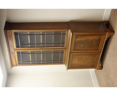 Early 20th century mahogany bookcase on cupboard, bookcase enclosed by two astragal glazed doors above figured panelled cupbo
