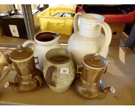 Shelf of ceramic jugs and tea pots etc