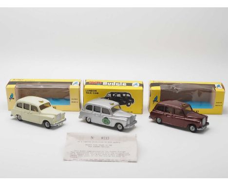 A group of 1:43 scale diecast Austin FX4 London Taxi models by BUDGIE, comprising: 1 x metallic brown, a limited edition silv