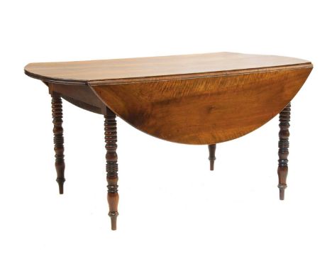 A French chestnut dining table,19th century, the oval drop-flap top with pegged decoration and on ring turned tapering legs,1