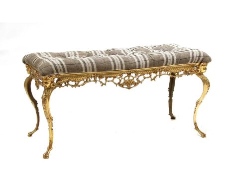 A gilt brass and button upholstered stool,early 20th century, with a pierced rococo-style frame and grey tartan seat cover,10