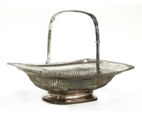 A George III silver bread basket, by Paul Storr, London 1812,the handle with stylised foliate designs and a neoclassical wrea