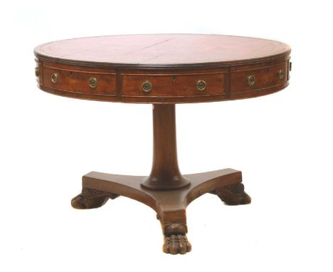 A Regency mahogany drum table, c.1820, the red leather inset top over four drawers and four false fronts, on a spreading colu