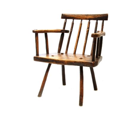 A primitive fruitwood stick back armchair,late 18th/early 19th century, probably West Country or Welsh, with a block seat on 