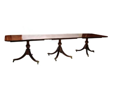A large George III-style mahogany dining table, 20th century, the rectangular top with rounded corners, raised on a triple pe