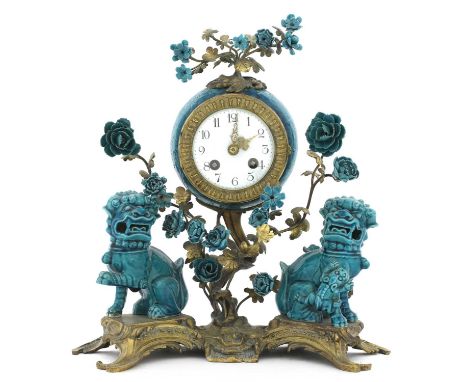 A French ormolu table clock,19th century, with Kangxi period turquoise porcelain temple dogs, flowers and clock case, the clo