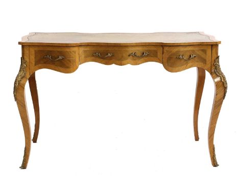 A French Louis XIV-style rosewood writing table, 20th century, the shaped leather top over three drawers and on shaped legs, 
