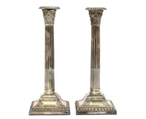A pair of Victorian silver Corinthian column candlesticks, by Henry Wilkinson &amp; Co., London 1872,on loaded acanthus cast 