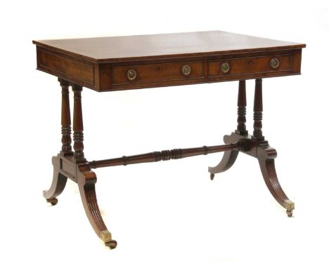 A Regency mahogany and rosewood banded library table, c.1820, with ebony line stringing, two frieze drawers, on twin column s