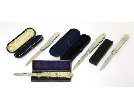 Four Victorian carved mother-of-pearl and silver folding fruit knives,each with shaped and engraved handles and in a leather 