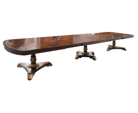 A very large George III-style mahogany and parcel-gilt dining table,20th century, the central quadripartite pedestal flanked 