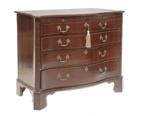 A George III mahogany serpentine chest, c.1770, with brushing slide, four long drawers and cast brass handles, blind fret ang