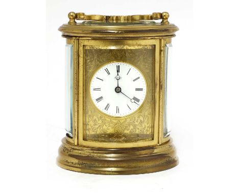 A gilt brass carriage clock,the white enamel dial with black Roman numerals, signed 'Simmons, Farham', the movement striking 