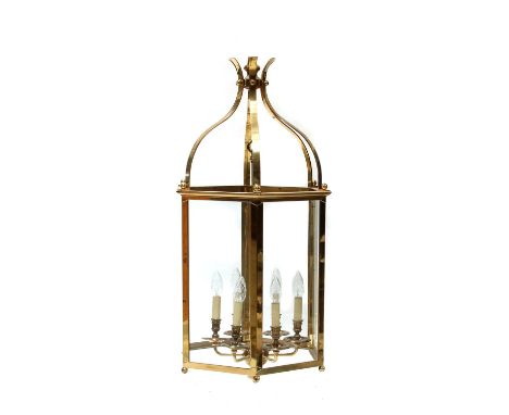A large brass-framed hexagonal six-light hall lantern, 20th century, with glazed panelled sides and scrolling support,64cm di