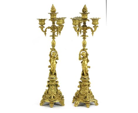 A pair of Continental ormolu four-light candelabra,19th century, the sconces supported on scrolling arms and figural supports