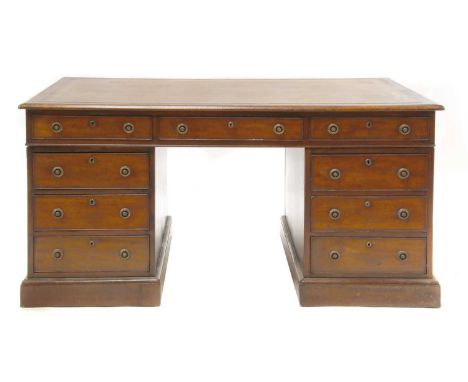 A Regency mahogany partners' desk,c.1810, the leather inset top over three frieze drawers to either side, with six further dr