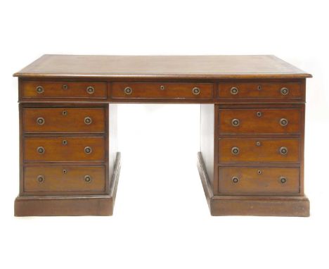 A Regency mahogany partners' desk,c.1810, the leather inset top over three frieze drawers to either side, with six further dr