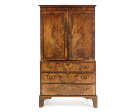 A mahogany and crossbanded linen press,early 19th century, opening to reveal sides, over a three-drawer chest and on bracket 