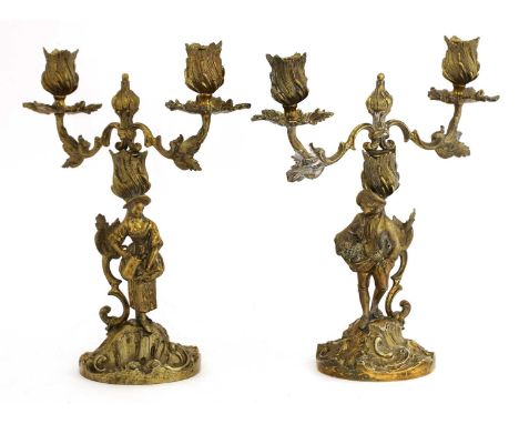 A pair of Elizabeth II silver gilt figural candelabra, by C J Vander Ltd., London 1962,cast in the rococo style with twin rem
