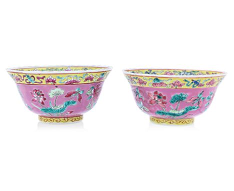 A PAIR OF PINK GROUND 'IN AND OUT' FAMILLE ROSE BOWLS
The exterior decorated with flowering foliage and insects on a pink gro