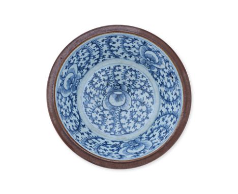 A BLUE AND WHITE PORCELAIN BASIN
The interio with scrolling foliate decoration, the exterior with cafe au lait glaze
28cm dia