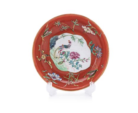 A CORAL RED GROUND FAMILLE ROSE SAUCER
Decorated with central quatrefoil panel depicting phoenix and peony, surrounded by ins