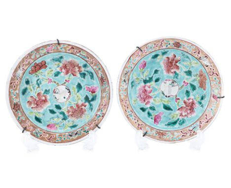 A PAIR OF FAMILLE ROSE 'CRANE' SAUCERS Decorated with peonies on green ground on cavetto, crane within central circular panel