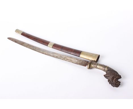 An Indian style Tulwar sword in brass and wooden scabbard with ornate carved pommel. 