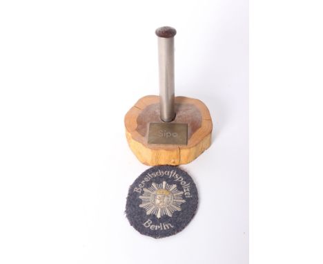 A telescopic metal cosh with SiPo grip with stand marked SiPo (Sicherheitspolizei (English: Security Police), often abbreviat