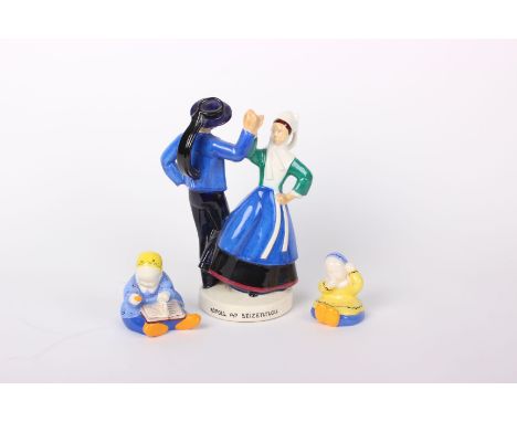 A Quimper pottery couple dancing (h: 35cm), signed by R Micheau Vernez and marked > to base, together with two figures of sea