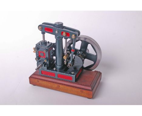 A model beam stationary engine in red and green livery on a mahogany plinth base. 25cm